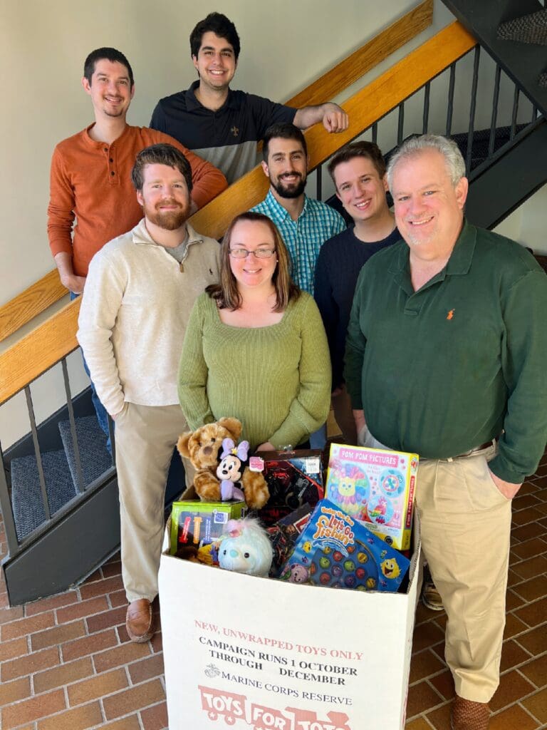 Mosaic Property Valuations team members with toys collected for Toys for Tots